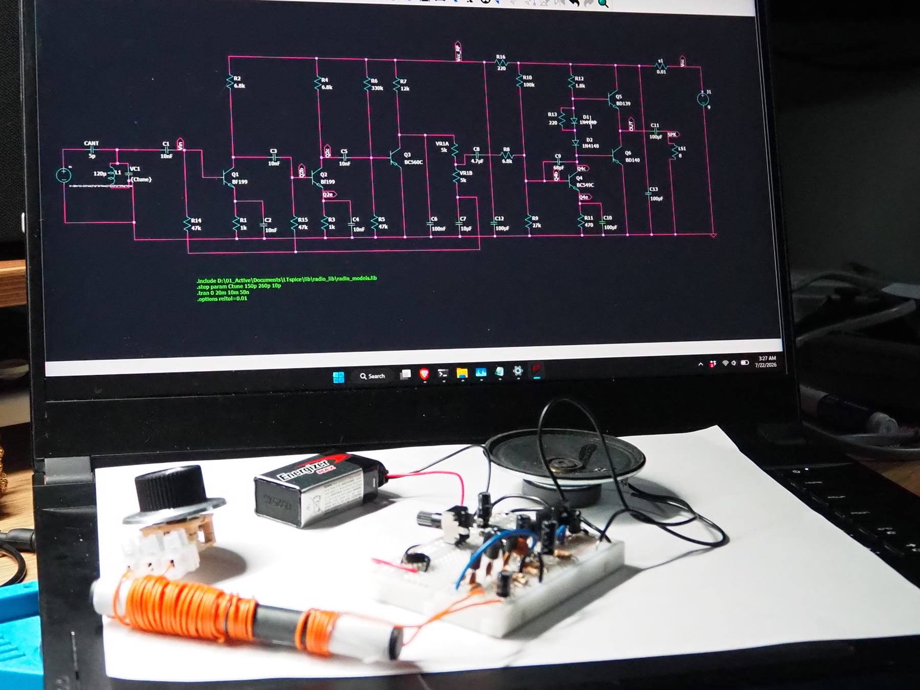Physical AM radio positioned in front of its LTspice schematic